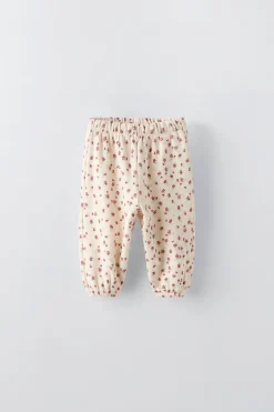 CALÇAS ESTAMPADAS COM FLORZINHAS-ZARA New